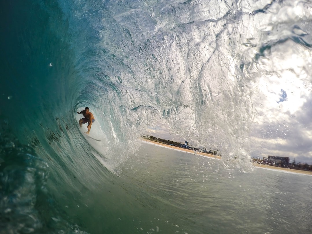 Surfer under a wave - Where did surf originate? Surfer under a wave