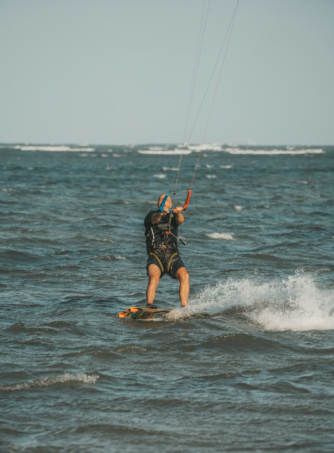 a man riding a kiteboard on top of a body of water